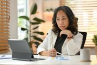 Smart professional senior business woman watching business training.